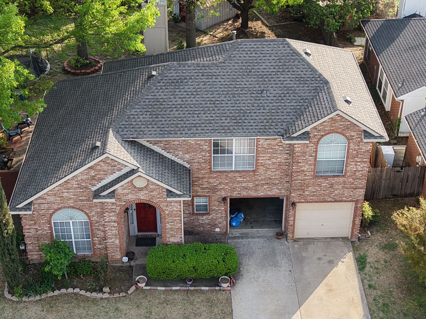 Aerial view of a completed shingle roof replacement in DFW